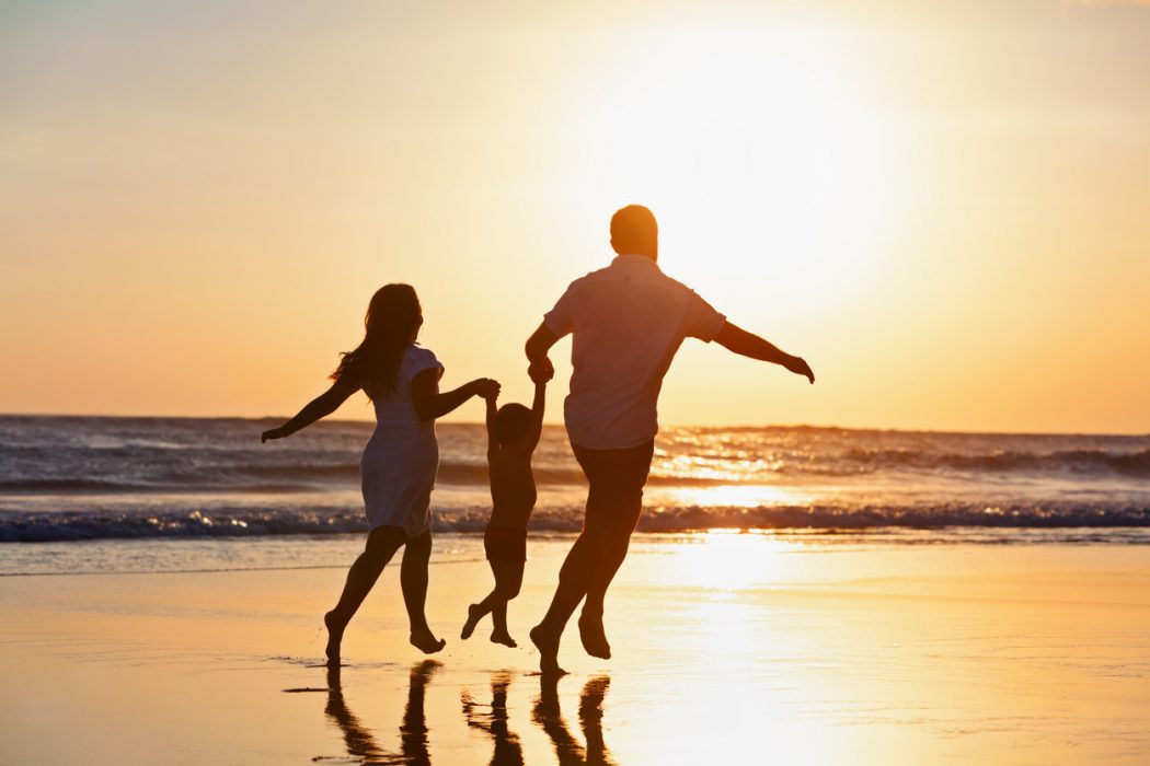 happy-family-running-by-sunset-beach-2